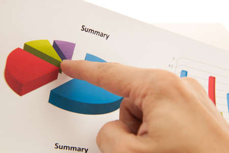 Male hand pointing at business reportの写真素材