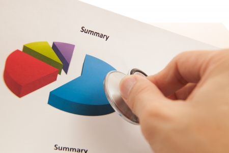 Financial charts and graphs with Stethoscopeの写真素材
