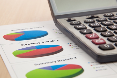 Financial graphs and charts with calculatorの写真素材