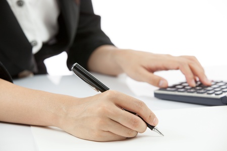 Business woman writing something on the paperの写真素材