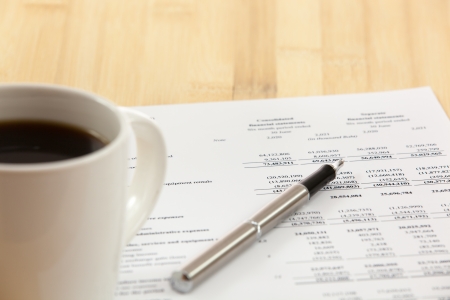 Business report. Cup of coffee on document.の写真素材