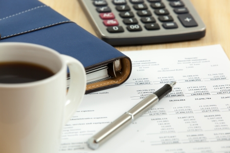 Business report. Cup of coffee on document.の写真素材