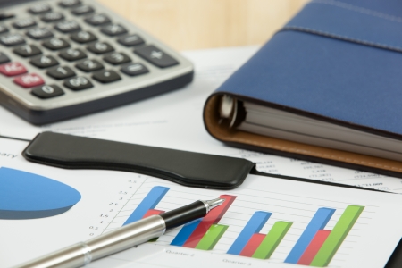 Financial graphs and charts with calculatorの写真素材