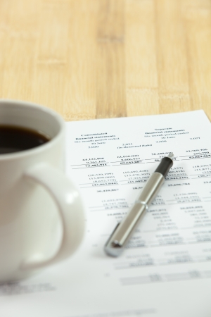 Business report. Cup of coffee on document.の写真素材