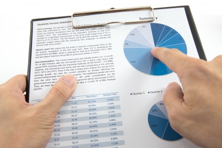 Businessman's hand showing diagram on financial reportの写真素材