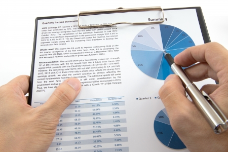 Businessman's hand showing diagram on financial reportの写真素材