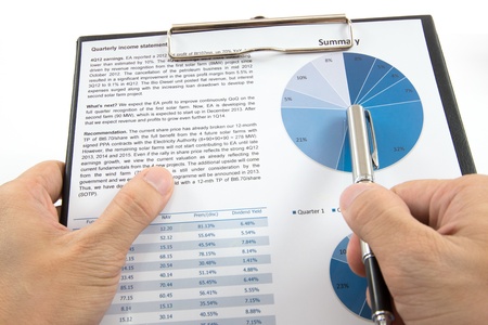 Businessman's hand showing diagram on financial reportの写真素材