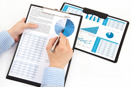 graphs and charts analyzed by businessmanの写真素材