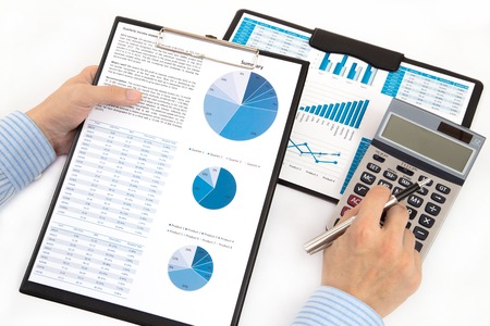 graphs and charts analyzed by businessmanの写真素材