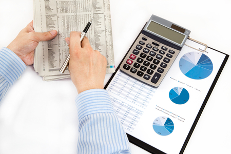 graphs and charts analyzed by businessmanの写真素材