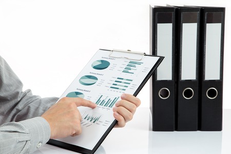 Graphs and charts analyzed by businessmanの写真素材