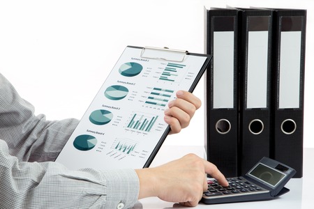 Graphs and charts analyzed by businessmanの写真素材