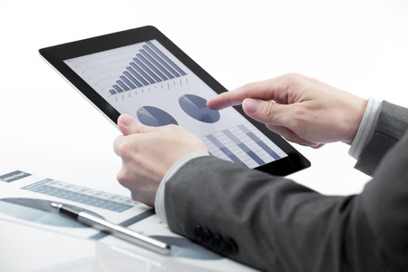 Businessman holding digital tablet with business reportの写真素材