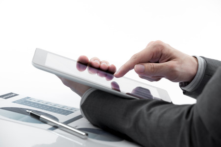 Businessman holding digital tablet with business reportの写真素材