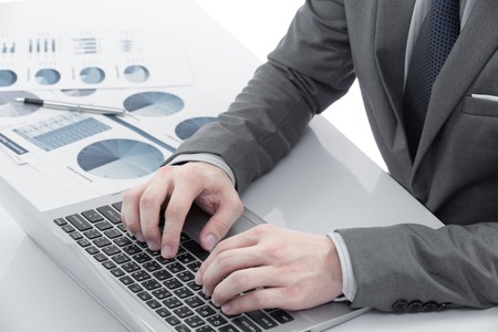 Graphs and charts analyzed by businessman on tableの写真素材