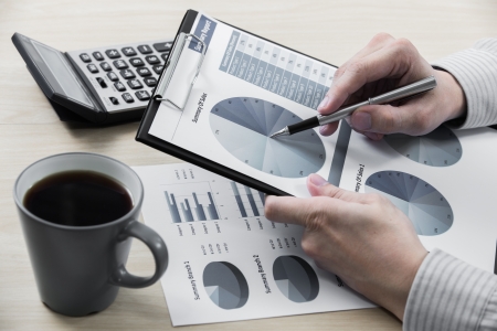 Business chart showing financial success with coffeeの写真素材