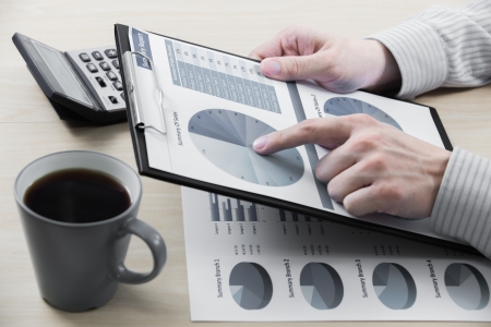 Business chart showing financial success with coffeeの写真素材