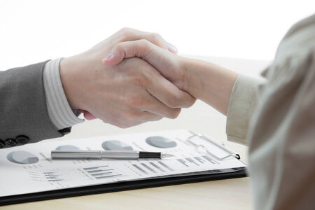 Business handshake and business people with Business Reportの写真素材