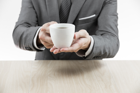 Businessman makes coffee break. Close upの写真素材