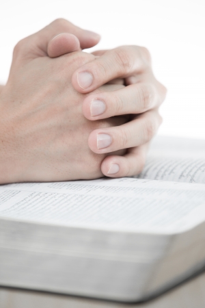 hands praying with bible on tableの写真素材