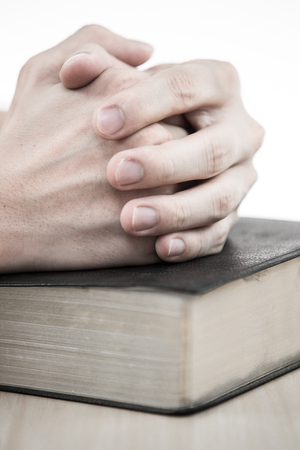 hands praying with bible on tableの写真素材
