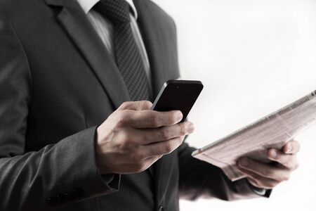 Businessman reading a newspaper, hand close upの写真素材