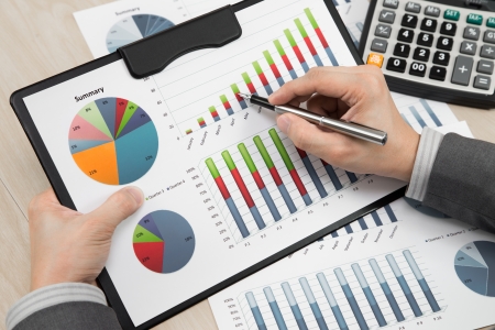 business report and man hand with penの写真素材