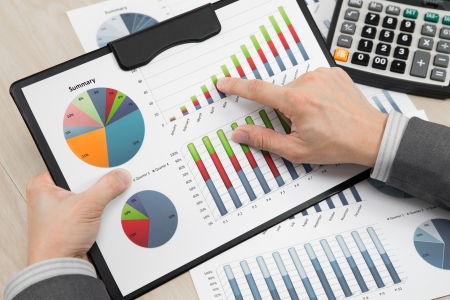 business report and man hand with penの写真素材