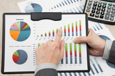 business report and man hand with penの写真素材