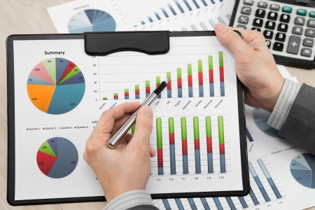 business report and man hand with penの写真素材