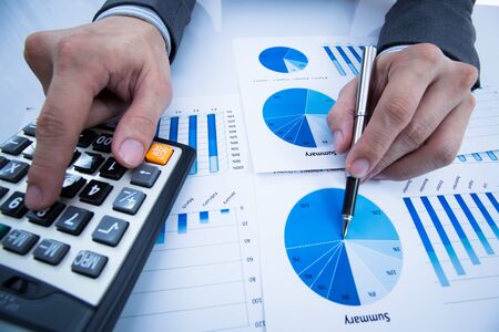 Businessman hand showing growing chart on tableの写真素材