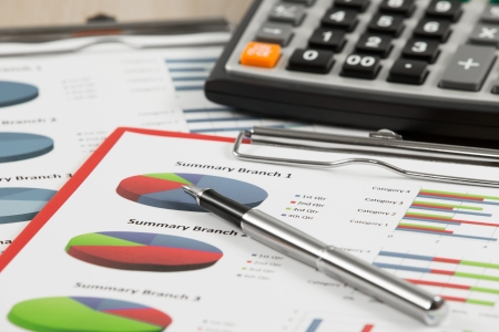 Financial graphs and charts with calculatorの写真素材