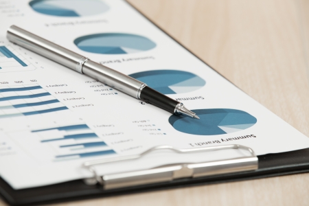 Businessman's hand showing financial report on tableの写真素材