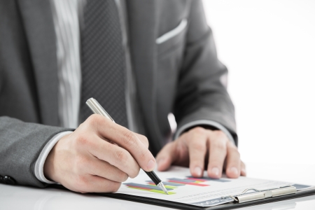 man hand with pen and business reportの写真素材