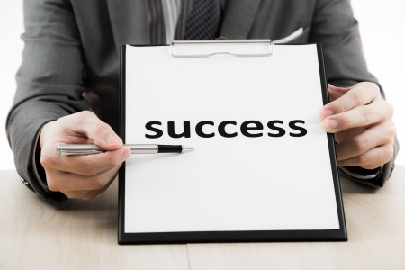 Businessman showing text success on tableの写真素材