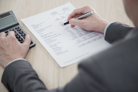 business report and man hand with pen. Accountingの写真素材