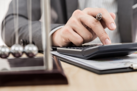 Businessman's hand showing financial report on tableの写真素材