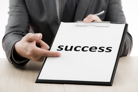 Businessman showing text success on tableの写真素材