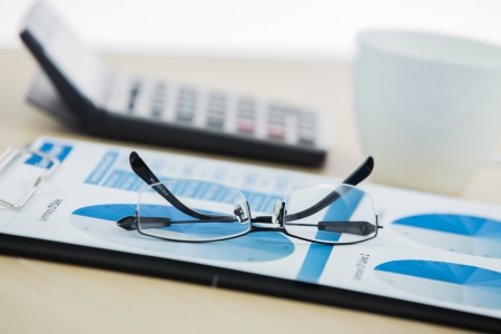 graphs and charts analyzed by businessman with coffeeの写真素材