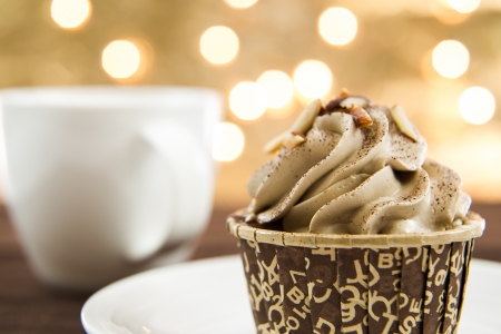Tasty cupcake with butter cream on lights backgroundの写真素材