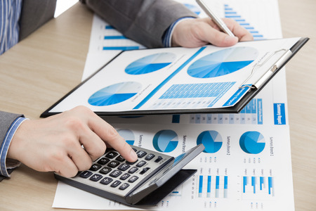 business report and man hand with pen. Accountingの写真素材