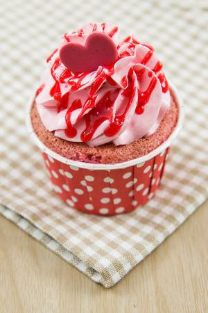 Tasty cupcake with butter cream on lights backgroundの写真素材