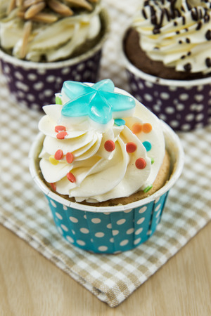Tasty cupcake with butter cream on lights backgroundの写真素材