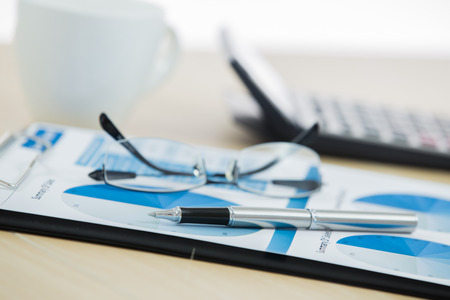 graphs and charts analyzed by businessman with coffeeの写真素材