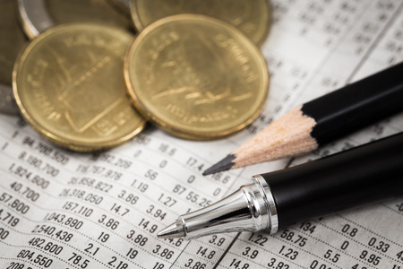 Business diagram on financial report with coins. Accountingの写真素材