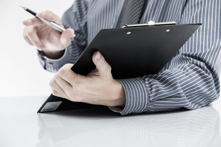 man hand with pen and business reportの写真素材
