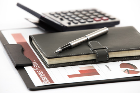 business financial chart analysis with calculator, pen and diaryの写真素材