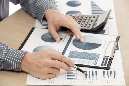 business report and man hand with penの写真素材