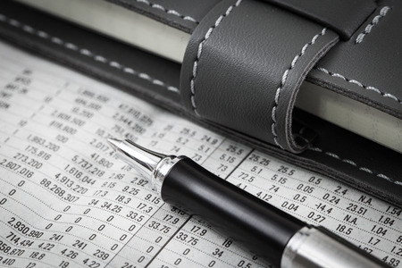 business and financial report with diary and penの写真素材