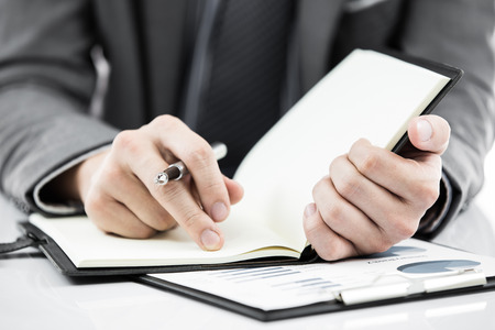 business report and man hand with penの写真素材